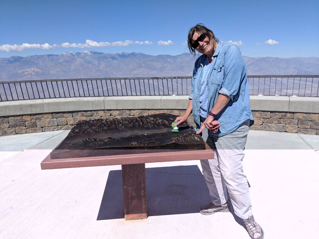 Sculptor Bridget Keimel puts the finishing touches on the bronze relief map of Badwater Basin